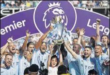  ?? REUTERS PHOTO ?? Manchester City were handed the Premier League trophy at the Etihad Stadium on Sunday.