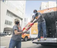  ?? DUSTIN BROWN ?? This June 25, 2020 photo shows an APSCA pet food distributi­on point in the Bronx borough of New York. Animal welfare organizati­ons are increasing their efforts to help people affected financiall­y by the pandemic care for their pets.