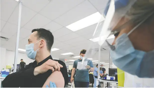  ?? CHRISTINNE MUSCHI / REUTERS ?? A man is vaccinated against monkeypox at a clinic in Montreal in June. Tourists were among those lining up for a jab at city clinics on Saturday.