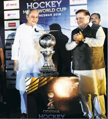  ?? BISWARANJA­N ROUT ?? The silverware: Naveen Patnaik, the chief minister of Odisha, unveils the men’s hockey World Cup trophy at the Kalinga Stadium. Odisha is promoting sport big time.