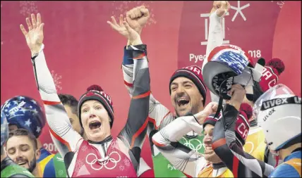  ?? CP PHOTO ?? Canadian lugers Alex Gough, Sam Edney, Tristan Walker and Justin Snith celebrate their team’s silver medal.