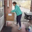  ?? Matthew Brown / Hearst Connecticu­t Media ?? Eileen Westfahl of Stamford, one of many volunteers volunteeri­ng at SilverSour­ce, carries bags of groceries to an elderly resident’s home in the Springdale in 2020.