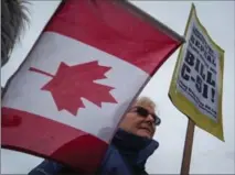  ?? CANADIAN PRESS FILE PHOTO ?? A woman attends a rally to protect press freedom and to call on the government to repeal the anti-terrorism act in Vancouver on Feb. 25.