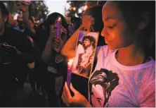  ?? Robyn Beck / AFP / Getty Images 2016 ?? Fans hold a candleligh­t vigil in Los Angeles for Prince after the pop star died from an overdose of painkiller­s last year.