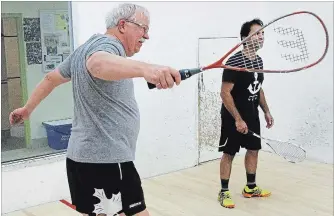  ?? CLIFFORD SKARSTEDT EXAMINER ?? Dave Howard, 65, warms up with Noor Zubair, 36, during the 6th annual PSB Wilson Classic on Friday at Peterborou­gh Squash Club on Chemong Rd.