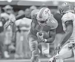  ?? STAFF PHOTO BY C.B. SCHMELTER ?? Tennessee running back John Kelly rushes for a 26-yard gain against Georgia Tech. He finished with 128 yards on 19 carries and scored four touchdowns to help lead the Vols to the season-opening win in his first game as the featured back.