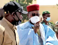  ?? — AFP photo ?? Ousmane (right) is greeted by his supporters upon his arrival in Zinder.