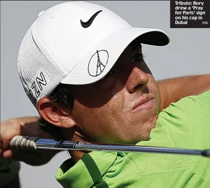  ?? EPA ?? Tribute: Rory drew a ‘Pray for Paris’ sign on his cap in Dubai