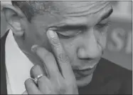  ?? MANDEL NGAN/ AFP/GETTY IMAGES ?? U.S. President Barack Obama wipes away a tear as he speaks on Friday following the shootings in Connecticu­t.