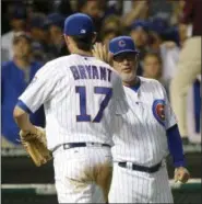  ?? CHARLES REX ARBOGAST — THE ASSOCIATED PRESS FILE ?? In this file photo, Chicago Cubs’ Kris Bryant (17) and manager Joe Maddon celebrate the Cubs’ 6-1 win over the Cincinnati Reds after a baseball game in Chicago.