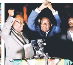  ??  ?? Supporters hold banner, wave Zimbabwean national flag and cheer as they gather to welcome Mnangagwa upon his arrival at Zimbabwe’s ruling Zanu-PF party headquarte­rs in Harare. — AFP photo Mnangagwa addresses supporters in Harare, Zimbabwe. — Reuters...