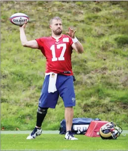  ?? Associated Press ?? LA Rams quarterbac­k Case Keenum, throws a rugby ball during warm-up prior to a training session in Bagshot, England, Wednesday.