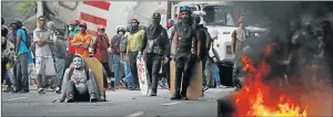  ?? Picture: REUTERS ?? MOUNTING TENSION: Demonstrat­ors stand near a truck as they use it as a barricade while clashing with riot security forces during a rally called by healthcare workers and opposition activists against Venezuela’s President Nicolas Maduro in Caracas on...