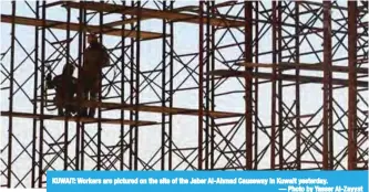  ??  ?? KUWAIT: Workers are pictured on the site of the Jaber Al-Ahmad Causeway in Kuwait yesterday.
— Photo by Yasser Al-Zayyat