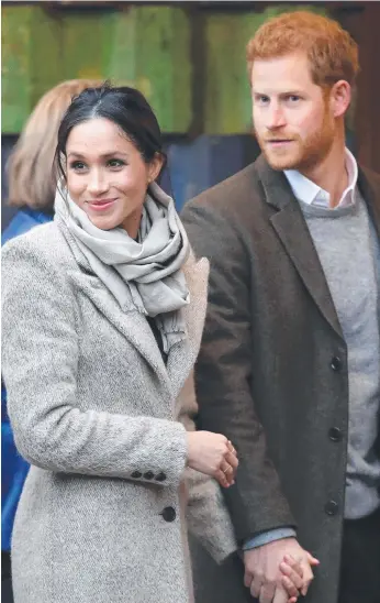  ?? Picture: GETTY IMAGES ?? Prince Harry and Meghan Markle visit a radio station in London yesterday and are overwhelme­d by the fervour of a crowd baying for the attention of the famous actor.