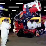  ??  ?? IN ACTION: Abu Dhabi Civil Defence officials use TAF35 firefighti­ng robot for sterilisat­ion drive in Capital.