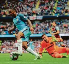  ?? AFP ?? Manchester City’s Raheem Sterling scores his second goal against West Ham yesterday. Man City won 3-1.