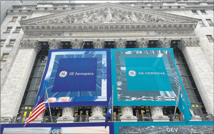 ?? Peter Morgan The Associated Press ?? General Electric banners hangs on the facade of New York Stock Exchange on Tuesday in New York.