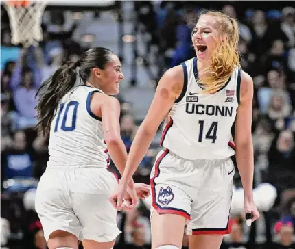  ?? Jessica Hill/Associated Press ?? UConn’s Nika Muhl (10) celebrates with Dorka Juhasz after Juhasz hit a 3-pointer against Florida State in December.