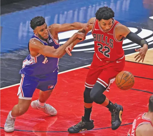  ?? JONATHAN DANIEL/GETTY IMAGES ?? Bulls forward Otto Porter Jr. steals the ball from 76ers center Tony Bradley on Thursday night at the United Center.