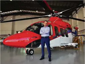  ??  ?? Leonardo Helicopter­s vice-president of sales for Asia Pacific Vincenzo Alaimo with the company’s AW139 helicopter.