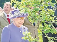  ??  ?? File photo shows Queen Elizabeth II looking at a tree planted in honour of her diamond jubilee in Hatfield Park in Hertfordsh­ire during her jubilee tour of the country. — AFP photo