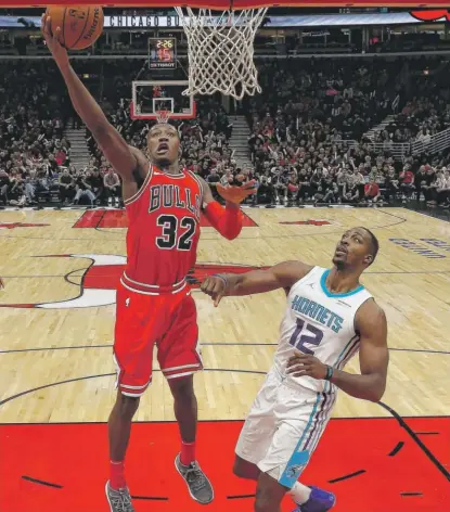  ?? | JIM YOUNG/ AP ?? The Bulls’ Kris Dunn scored a career- high 22 points on 10- for- 16 shooting Friday against the Hornets.