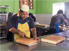  ??  ?? Family affair: Mokhtar Amat, working in his bakery, and his family are the only ones from his village who will be voting in the coming by-election. — RONNIE CHIN/The Star