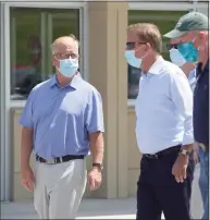  ?? H John Voorhees III / Hearst Connecticu­t Media file photo ?? Gov. Ned Lamont talks with Mark Boughton, then the Danbury mayor, before a press conference in Danbury in 2020. Boughton is now the state tax commission­er.