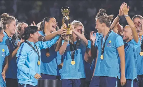  ?? Picture: AP ?? WORTHY CHAMPIONS: Members of the Australian team hold up their trophy after they defeated Brazil 6-1.