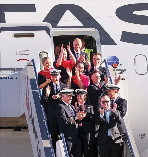  ?? AFP ?? Project Sunrise is Qantas’ goal to operate regular, non-stop commercial flights from Australia’s east coast cities to London and New York. Qantas CEO Alan Joyce, bottom right, welcomes the crew of a Qantas Boeing 787 Dreamliner after the completion of a non-stop test flight from New York to Sydney.