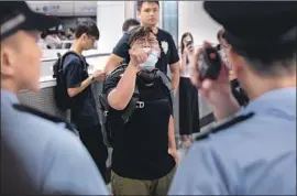  ?? Jerome Favre EPA/Shuttersto­ck ?? A PROTESTER shouts at Hong Kong police in a metro station. Public fury has swelled over the police force’s slow response after thugs attacked demonstrat­ors.