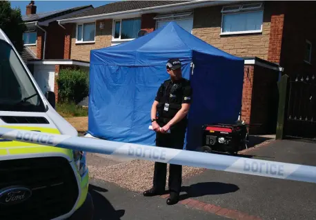  ??  ?? A police officer stands outside a house in Chester, England, which is being investigat­ed as part of the probe into the deaths of 17 babies at the local hospital. Photo: Getty Images