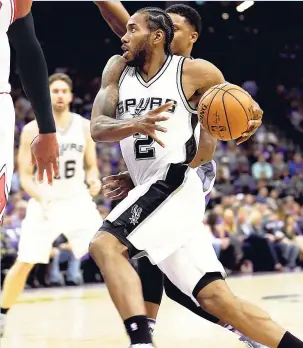  ?? AP ?? San Antonio Spurs forward Kawhi Leonard (right) drives to the basket against Sacramento Kings forward Rudy Gay in Sacramento, California, on Thursday night.