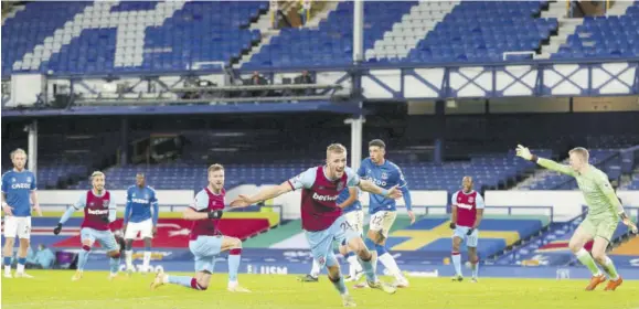  ??  ?? West Ham United’s Czech midfielder Tomas Soucek (foreground) celebrates after scoring the opening goal of the English Premier League football match between Everton and West Ham United at Goodison Park in Liverpool, north-west England yesterday.