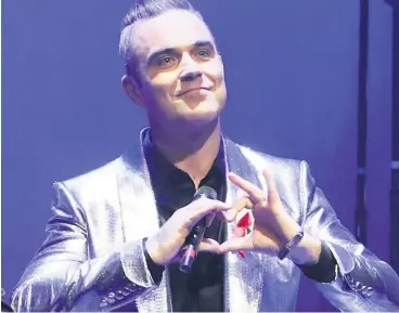  ??  ?? SLIM PICKINGS Robbie Williams is now an ambassador for WeightWatc­hers. Pic: David M. Benett/Getty Images