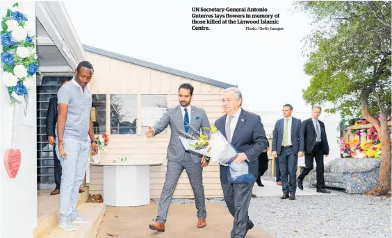  ?? Photo / Getty Images ?? UN Secretary-General Antonio Guterres lays flowers in memory of those killed at the Linwood Islamic Centre.