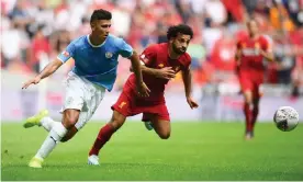  ??  ?? Rodri battles for the ball with Liverpool’s Mo Salah. The Spaniard looked a reassuring presence in midfield for the reigning champions. Photograph: Clive Mason/Getty Images