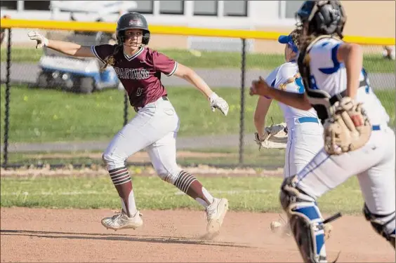  ?? Photos by Lori Van Buren / Times Union ?? Burnt Hills-ballston Lake sophomore Lily Haluska escapes from a rundown between second and third with the help of a throwing error in the third inning against Shaker on Friday in Latham. The Spartans took advantage as Haluska scored the go-ahead run on a groundout by Danielle Debonis.