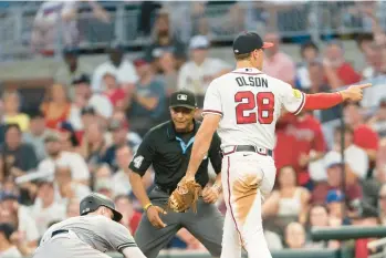  ?? HAKIM WRIGHT SR./AP YANKEES NOTES ?? Braves first baseman Matt Olson points after making a tag on the Yankees’ Harrison Bader during the sixth inning Monday night in Atlanta.