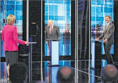  ?? Matt Frost The Associated Press ?? Britain’s Conservati­ve Party candidates Boris Johnson, center, and Jeremy Hunt with moderator Julie Etchingham during Tuesday’s debate. About 160,000 Conservati­ve Party members are voting for a successor to Prime Minister Theresa May.