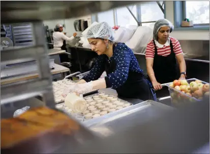  ?? DAI SUGANO — BAY AREA NEWS GROUP ?? Miller Middle School cook Anita Rathi, center, prepares some of 500cups of chipotle ranch salad dressing in the school kitchen on Tuesday, March 19, 2024, in San Jose, Calif.