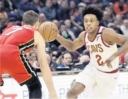  ?? TONY DEJAK/AP ?? The Cavaliers' Collin Sexton tries to drive past the Heat’s Goran Dragic in the first half Monday in Cleveland. Dragic scored 22 off the bench.