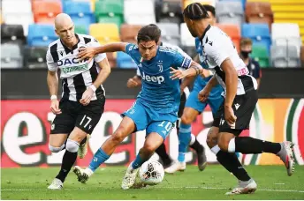  ?? — AFP photo ?? Juventus’ forward Paulo Dybala (centre) vies for the ball with Udinese’s defender Bram Nuytinck (left) and Udinese’s defender William Troost-Ekong during the Italian Serie A match at the Dacia Arena Stadium in Udine in this July 23 file photo.