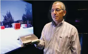  ?? (TNS) ?? SENIOR DIRECTOR Danny Shapiro holds the Nvidia Drive PX2 processor at company headquarte­rs in Santa Clara, California, in May.