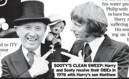  ?? ?? SOOTY’S CLEAN SWEEP: Harry and Sooty receive their OBES in 1976 with Harry’s son Matthew