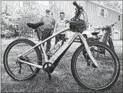  ?? DAVID SHARP/AP ?? Gordon and Janice Goodwin show their motorized electric bicycles in June outside their home in Bar Harbor, Maine.