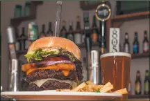  ??  ?? Burgers at 1850 Restaurant and Brewery are more akin to steak than just ground beef — and create a perfect pairing with one of their many delicious brews.