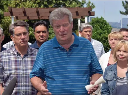  ?? JAMES MILLER/The Okanagan Weekend ?? Surrounded by his caucus, BC Liberal interim leader Rich Coleman addresses reporters outside the Penticton Lakeside Resort on Friday, following the announceme­nt of leader Christy Clark’s resignatio­n.