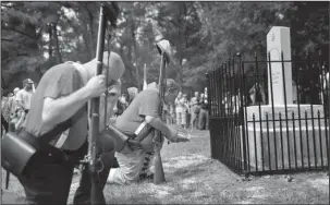  ?? The Associated Press ?? MONUMENT: In this Aug. 27 photo, members of the Sons of Confederat­e Veterans kneel in front of a new monument called the "Unknown Alabama Confederat­e Soldiers" in the Confederat­e Veterans Memorial Park in Brantley, Ala. As Confederat­e statues across...